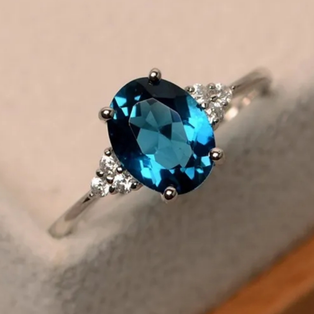 1/2 CT. TW. SWISS BLUE  ZIRCON AND LAB-CREATED DIAMOND RING IN S925